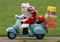 Babbo Natale trasporta regali alla guida di una Vespa © Ansa